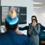 A surprised woman at an office party celebration with colleagues.